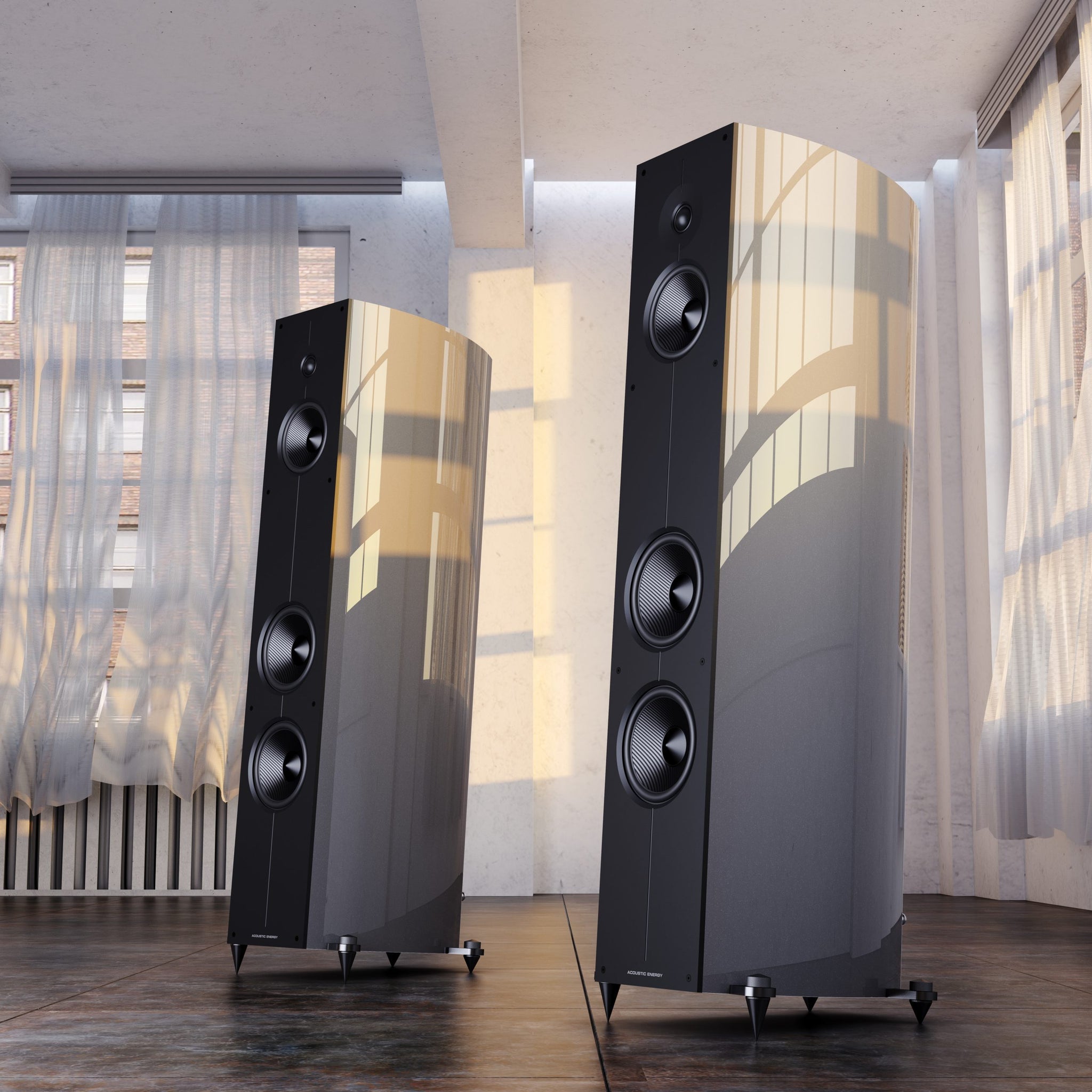 Pair of Acoustic Energy Corinium floor-standing speakers in a room with curtains