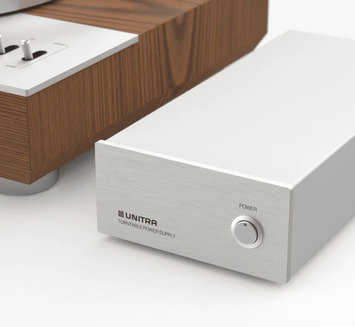 Silver electronic component with 'UNITRA' branding on a white surface.