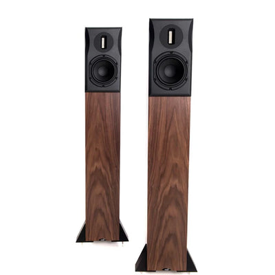 Neat Ekstra floor-standing tower speakers with a wooden finish, featuring a black front grille and a slim design.
