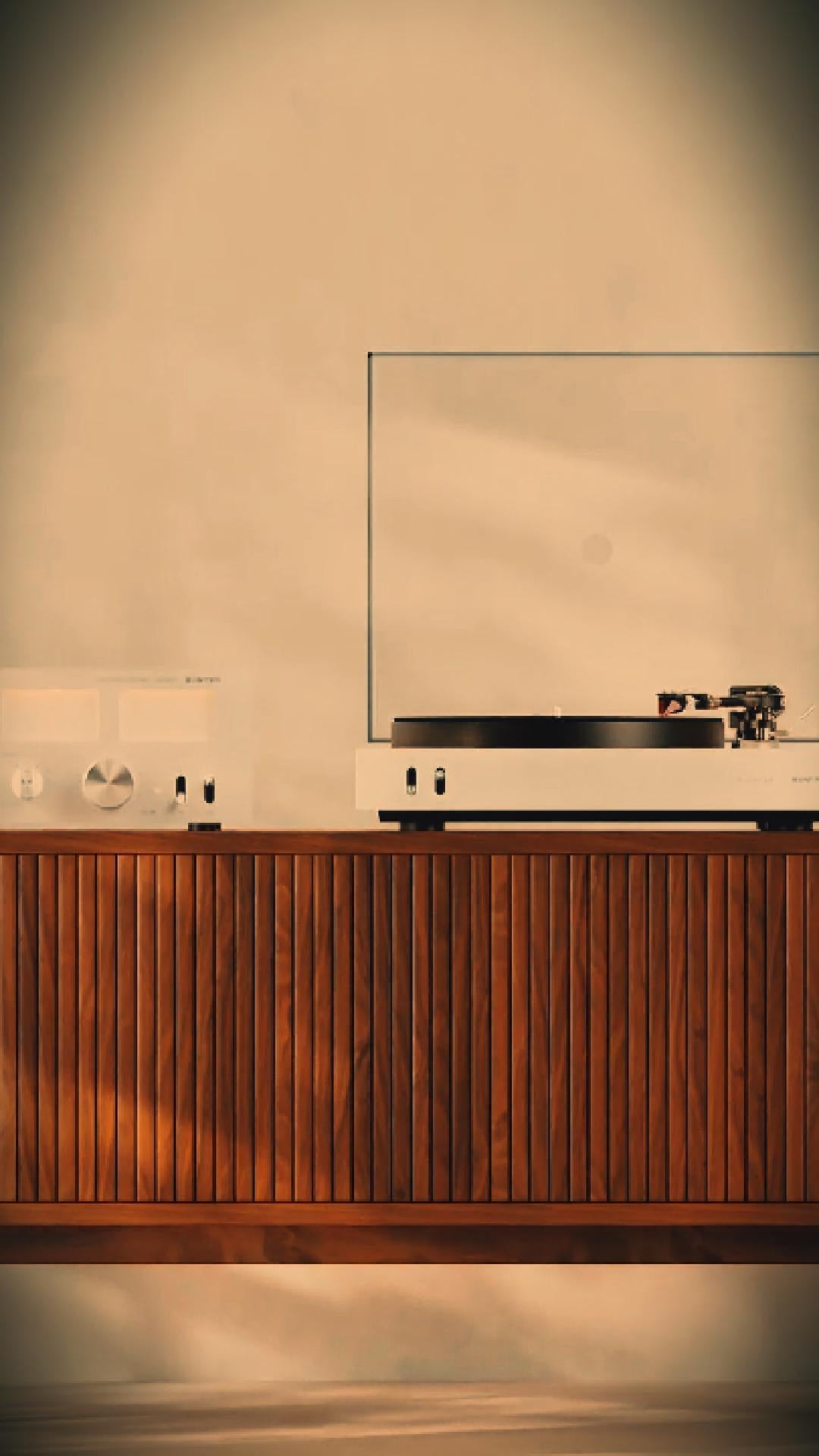 Unitra Audio record player and amplifier on a wooden cabinet with a warm, beige background