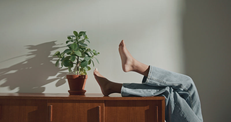 Feet moving to high fidelity sound and perched on a wooden cabinet